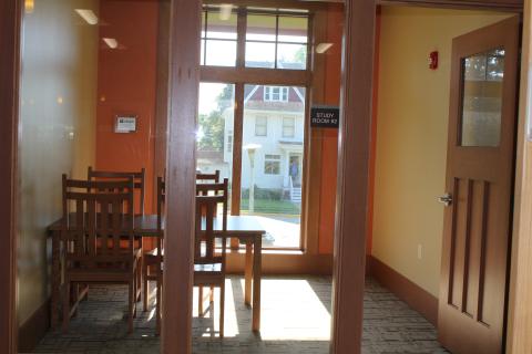 Room with exterior windows, table and 4 chairs.